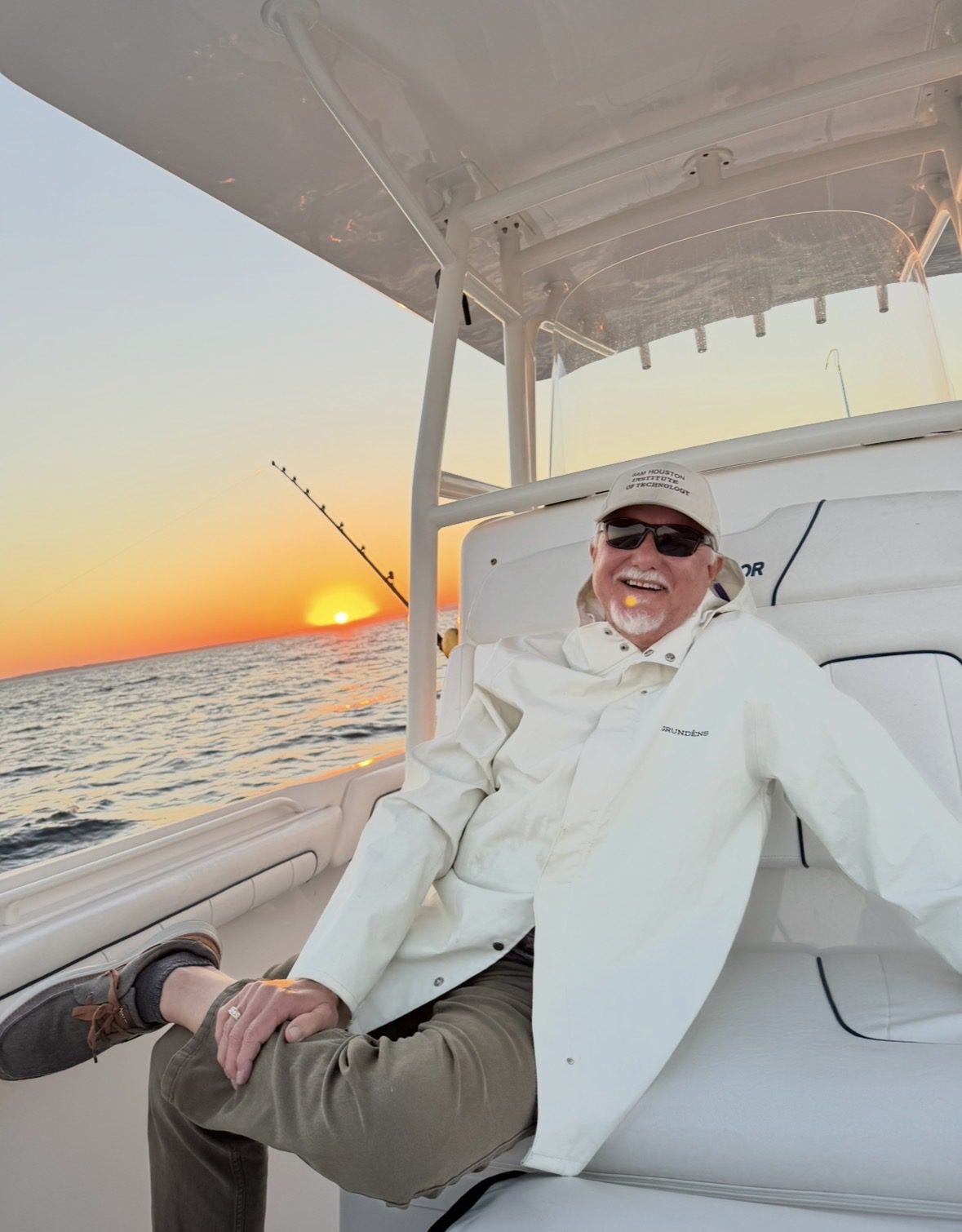 Man relaxing on a boat at sunset.