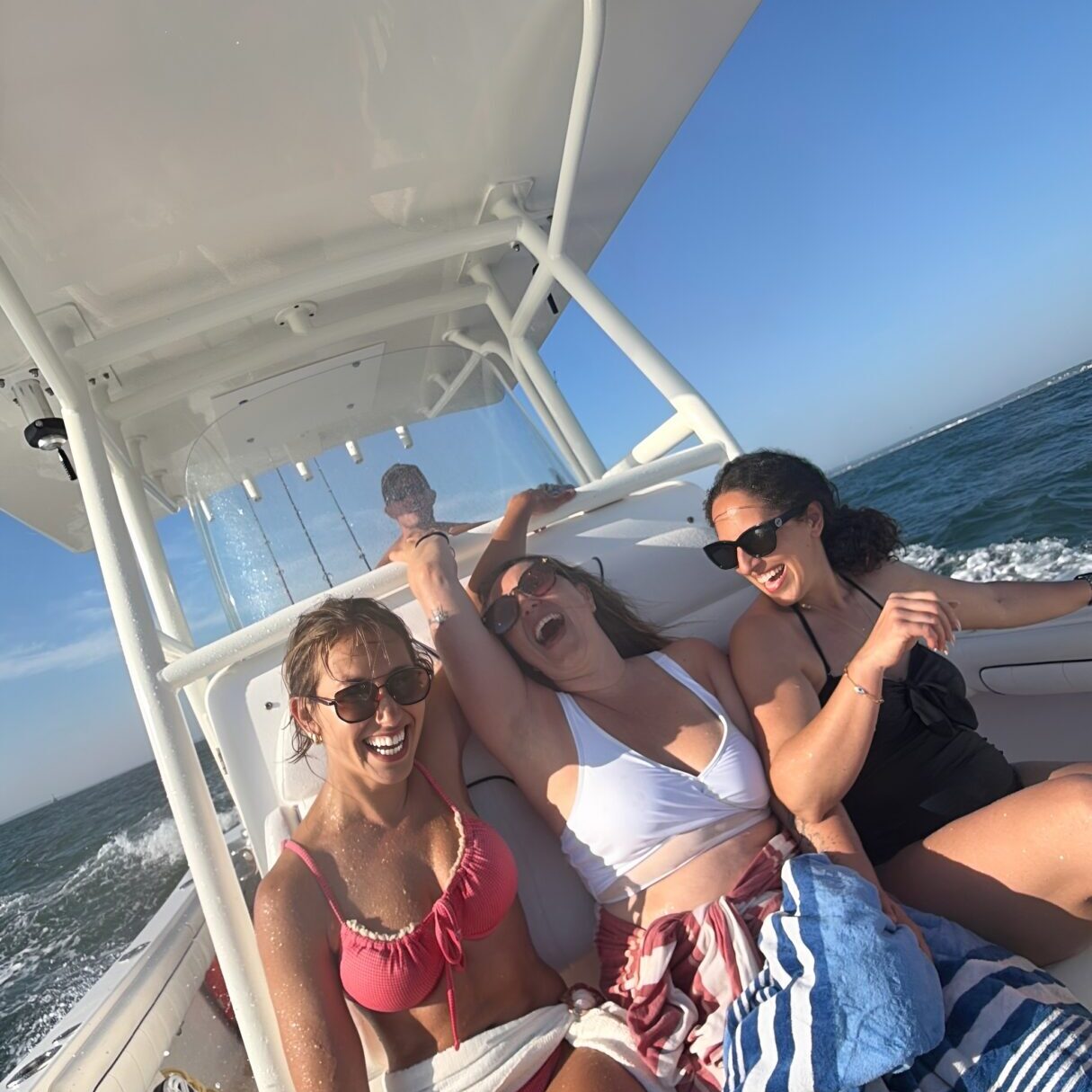 People enjoying a sunny boat ride.